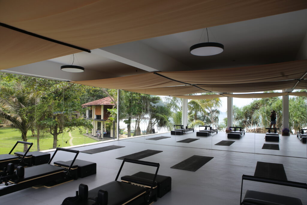 Open-air reformer Pilates studio overlooking the ocean at Talalla Retreat, Sri Lanka