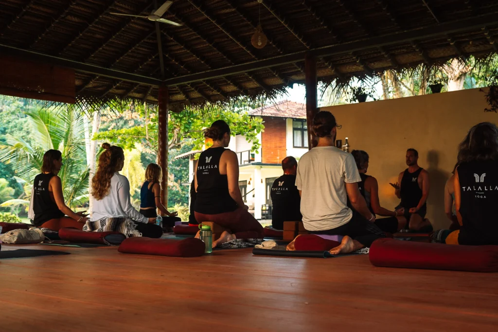 Group meditation session at the open-air yoga shala during a yoga retreat in Sri Lanka at Talalla Retreat