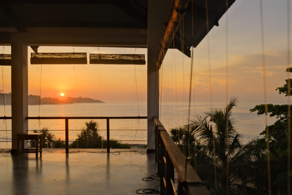 Open-air ocean-view yoga shala surrounded by jungle at Talalla Retreat, a yoga retreat in Sri Lanka