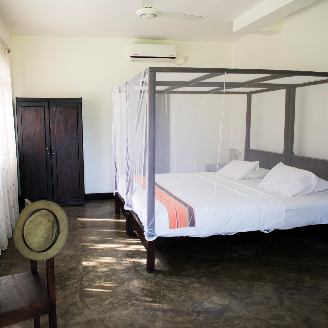 Sea-view ground-floor room with a four-poster bed at Talalla Retreat, Sri Lanka