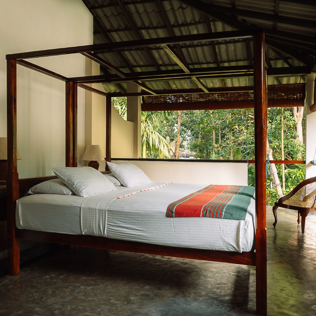 "Deluxe first-floor room with a four-poster bed at Talalla Retreat, Sri Lanka