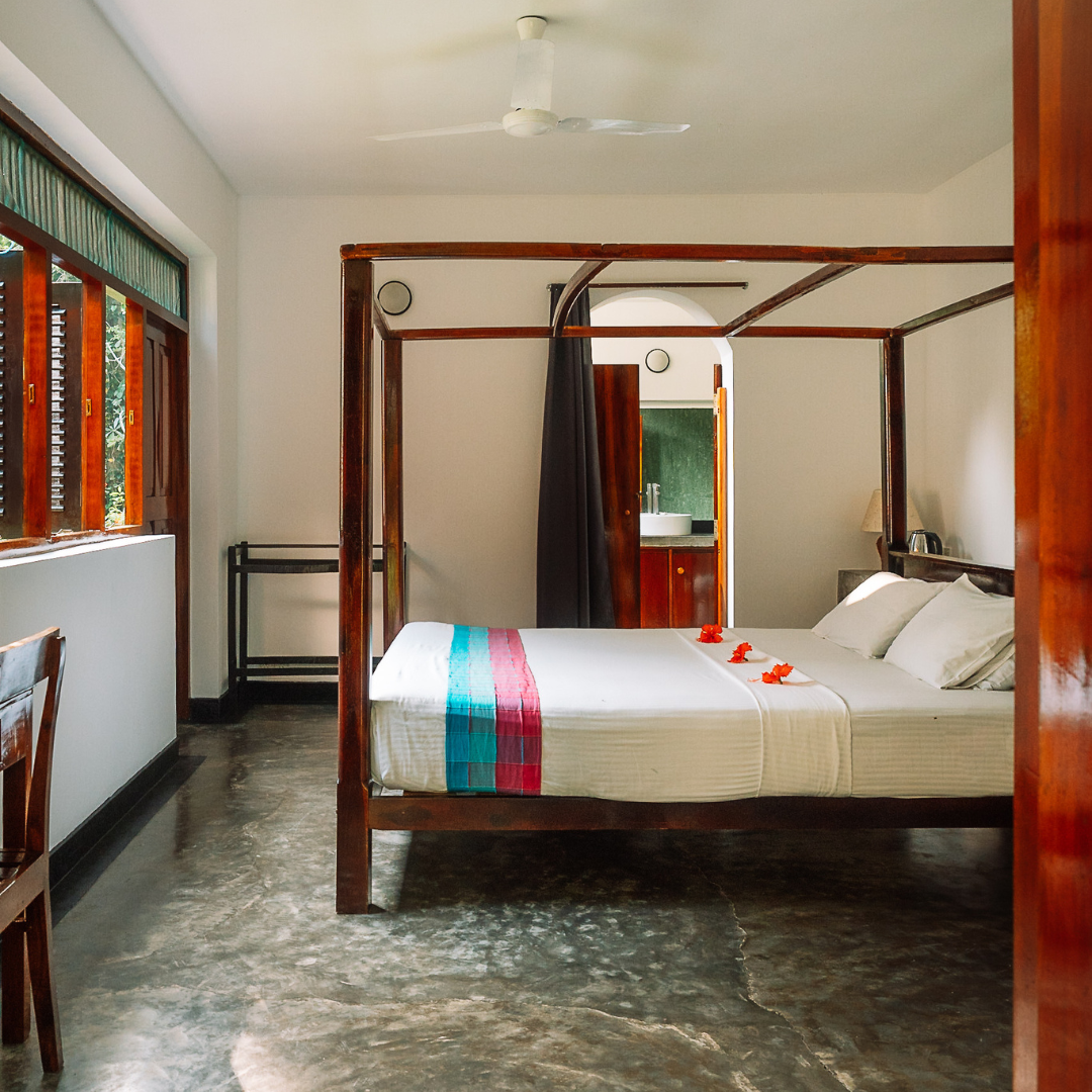 Deluxe ground-floor room with a four-poster bed at Talalla Retreat, Sri Lanka