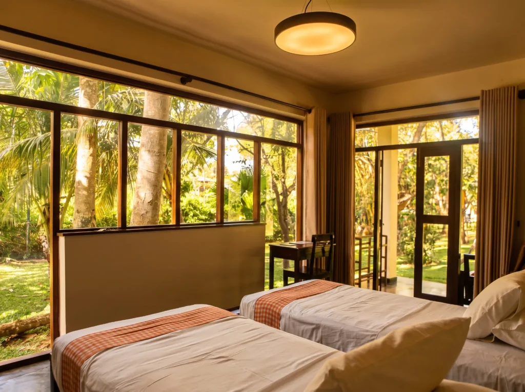 Twin room with large windows onto the garden at Talalla Retreat