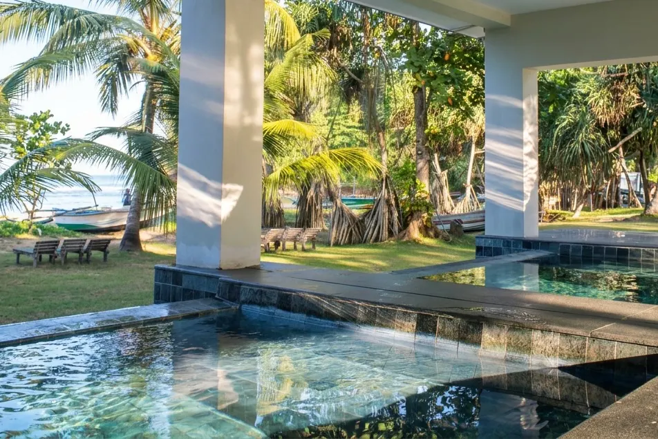 Plunge pool surrounded by palm trees at Talalla Retreat, Sri Lanka