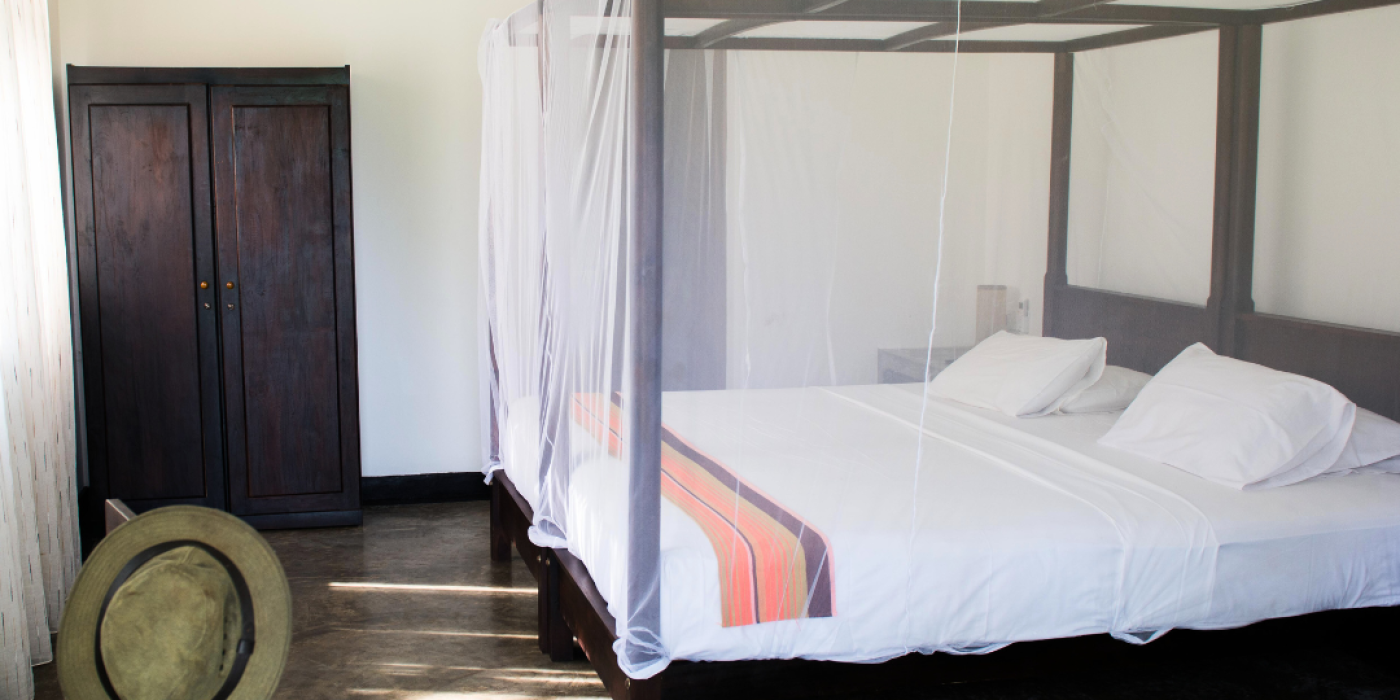 Sea-view ground-floor room with a four-poster bed at Talalla Retreat, Sri Lanka