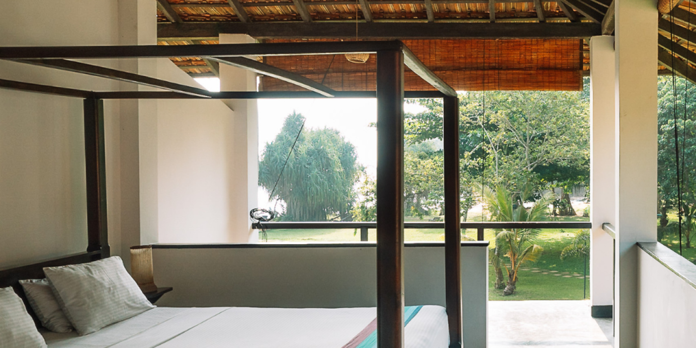 Sea-view first-floor room opening onto a balcony at Talalla Retreat, Sri Lanka
