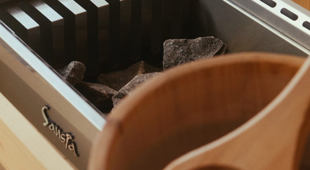 Wood-lined sauna with heater and stones at the Talalla Retreat bathhouse, Sri Lanka